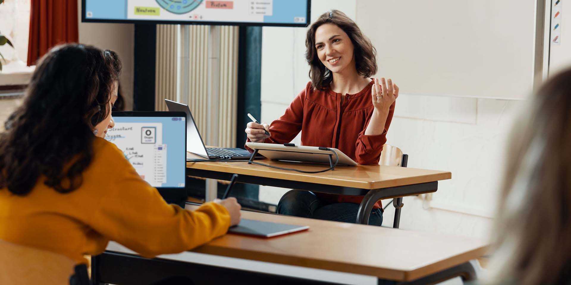 smiling teacher using wacom one tablet